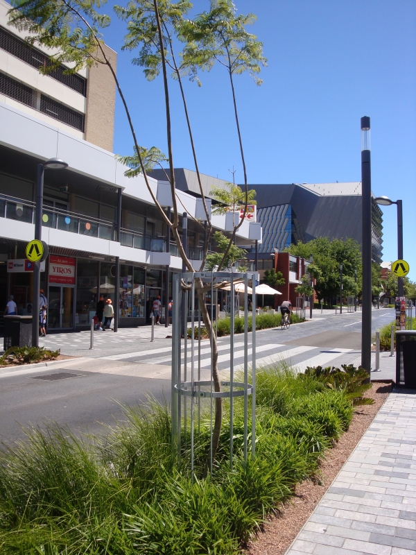 Integrated street design elements such as zebra crossings and greening can help to connect both sides of a Retail Street together