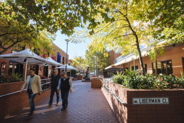 Integrated greening can be used to maintain pedestrian movement and sight lines and provide a human scale to the street 