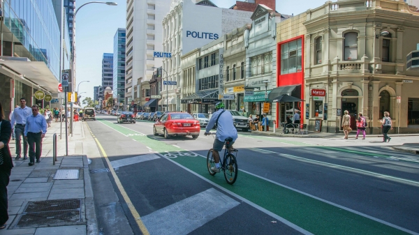 Greening bike lanes helps to provide a degree of separation between cars and bikes, and visually narrow a street environment